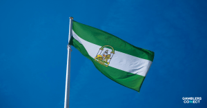 The green, white, and green flag of Andalusia waving against a blue sky, symbolising the regional government's new digital initiative to combat addiction.