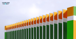 A magnifying glass resting on a textured blue surface, symbolizing thorough investigation, transparency, and scrutiny by regulatory bodies like the UK Gambling Commission.