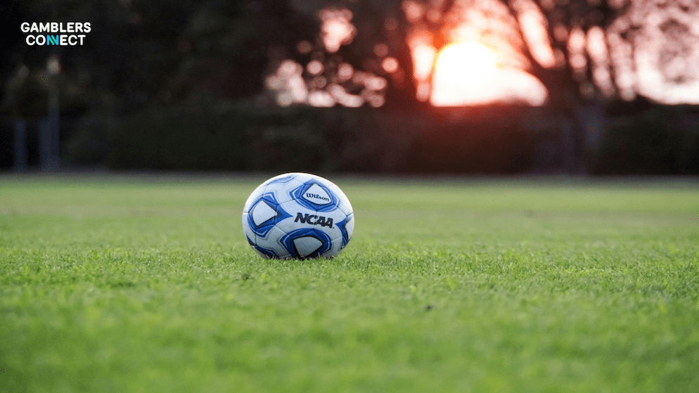 An NCAA basketball on a field, symbolizing the debate over college player prop bets and the integrity risks cited by the association.