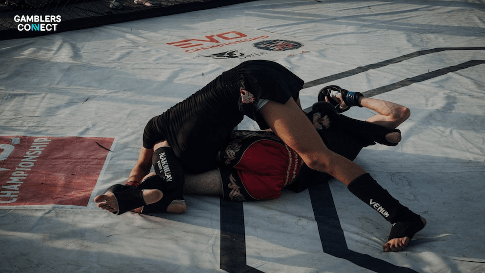Two MMA fighters grappling on the mat during a match, representing the scheduled bout between Michael Johnson and Alex Hernandez that was canceled due to integrity concerns.