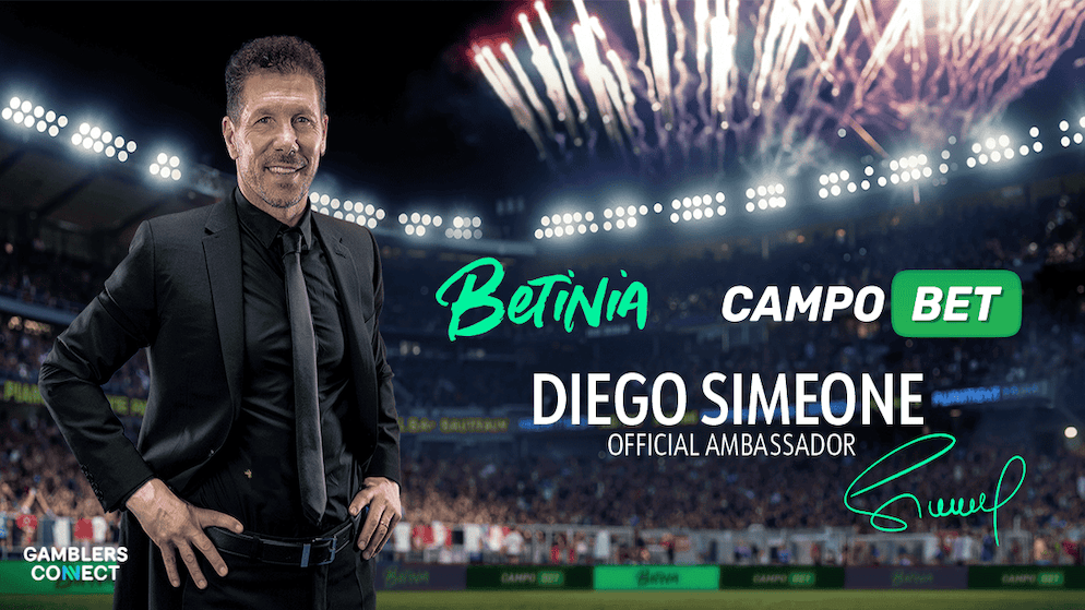 A promotional graphic featuring Diego Simeone in a suit, announcing his new role as the official ambassador for the Betinia and CampoBet brands against a celebratory stadium backdrop.