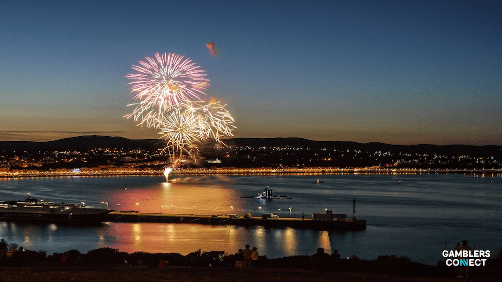 The corporate logo of Digital Isle of Man displayed on a glass office building entrance.