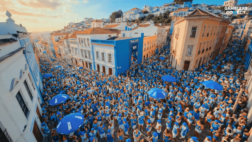 A busy street scene during Carnival in a Brazilian city like Recife or Salvador, featuring Esportes da Sorte branding on large Out-of-Home (OOH) displays amidst the crowd.