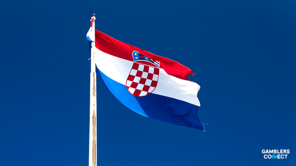 A low-angle view of the Croatian flag, representing the regulated market where FEG and Gaming Realms are now rolling out their direct integration.