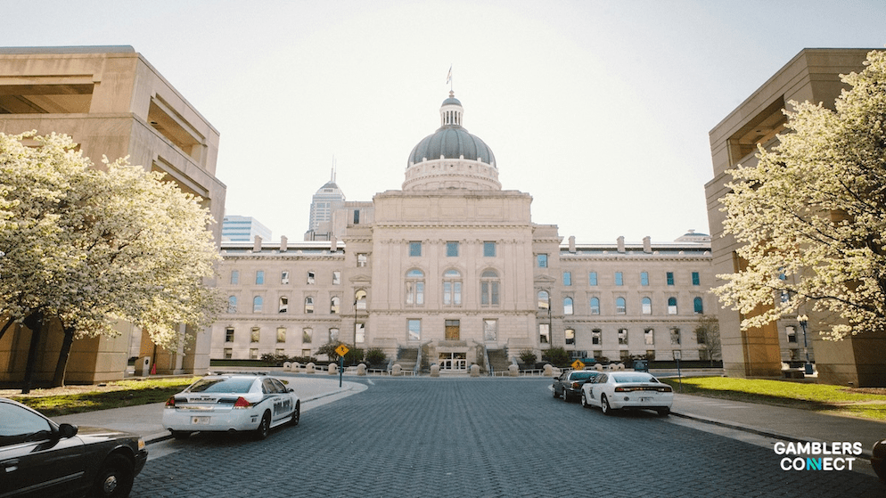 A panoramic night view of the Indianapolis city skyline representing the center of the state regulated sports betting industry.
