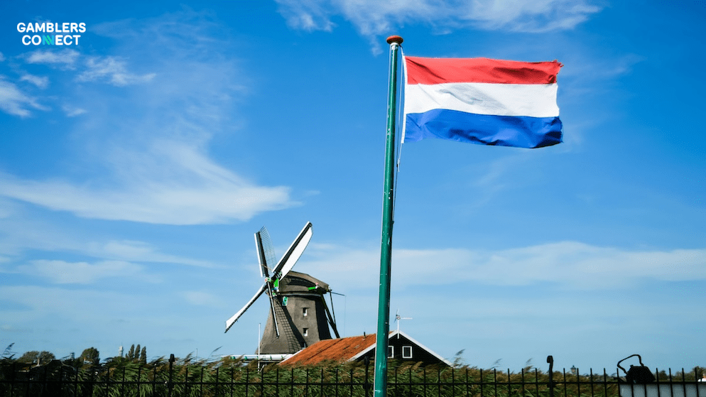 A Dutch flag and windmill symbolizing the strict regulatory environment in the Netherlands, where the KSA enforces monthly deposit limits of €300 for young players.