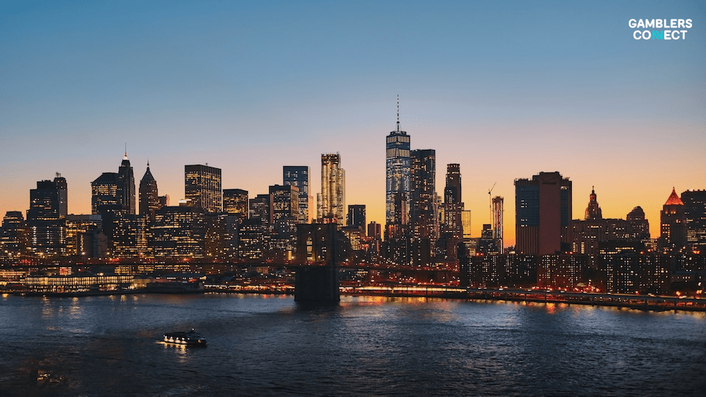 The illuminated skyscrapers of New York City at sunset, symbolising the high-stakes commercial environment of the state's gambling sector.