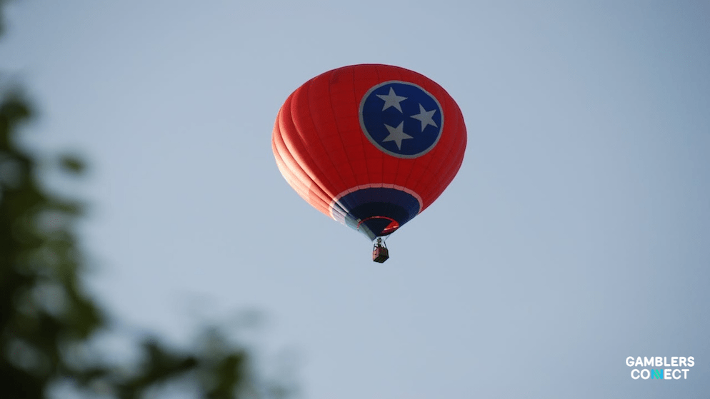 A low-angle view of a Tennessee-themed hot air balloon, representing the unique mobile-only sports wagering structure of the Volunteer State.