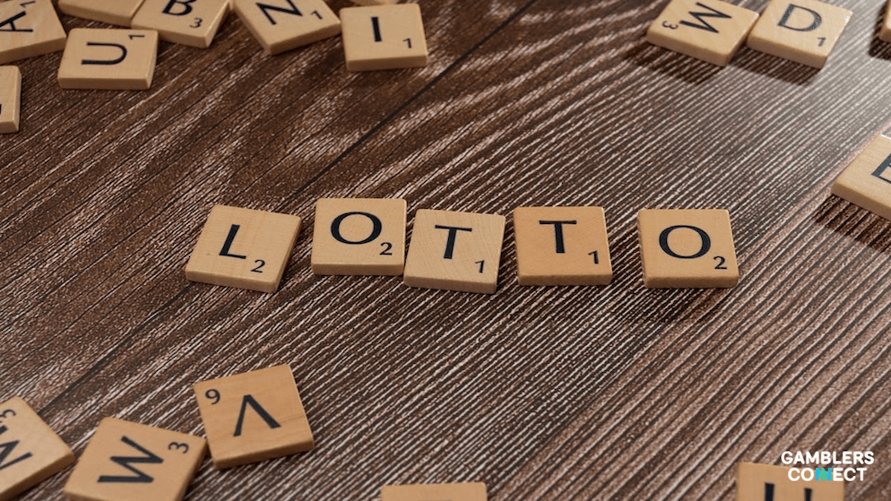 Wooden tiles spelling 'LOTTO' on a desk, representing the modernization of state lottery systems.