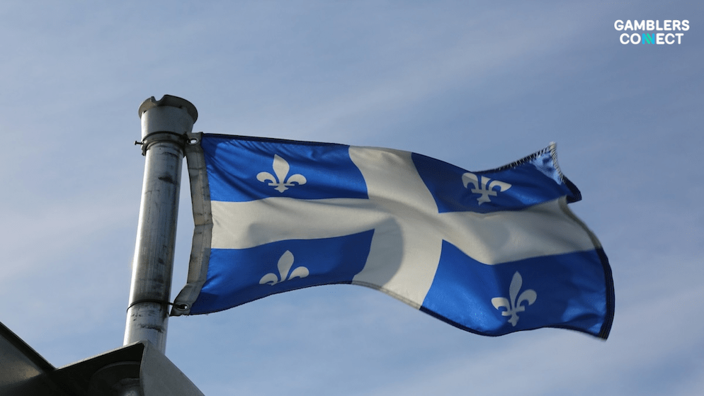 The flag of Québec waving against a clear sky, symbolizing Incentive Games' entry into the Canadian regulated market via Loto-Québec.