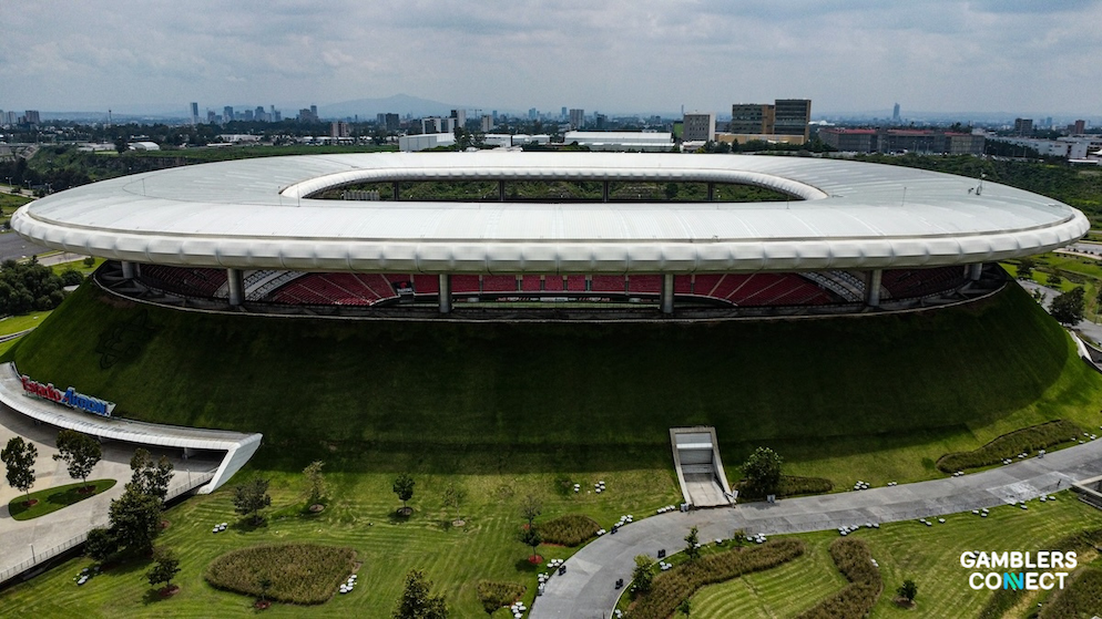 A close-up of the Mexican flag waving, symbolizing the state's tightening oversight of the gambling sector.
